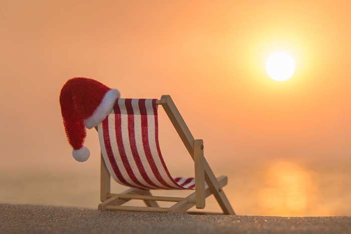chair on the beach with christmas hat